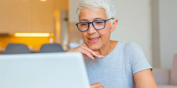 Senior woman comfortably using a laptop